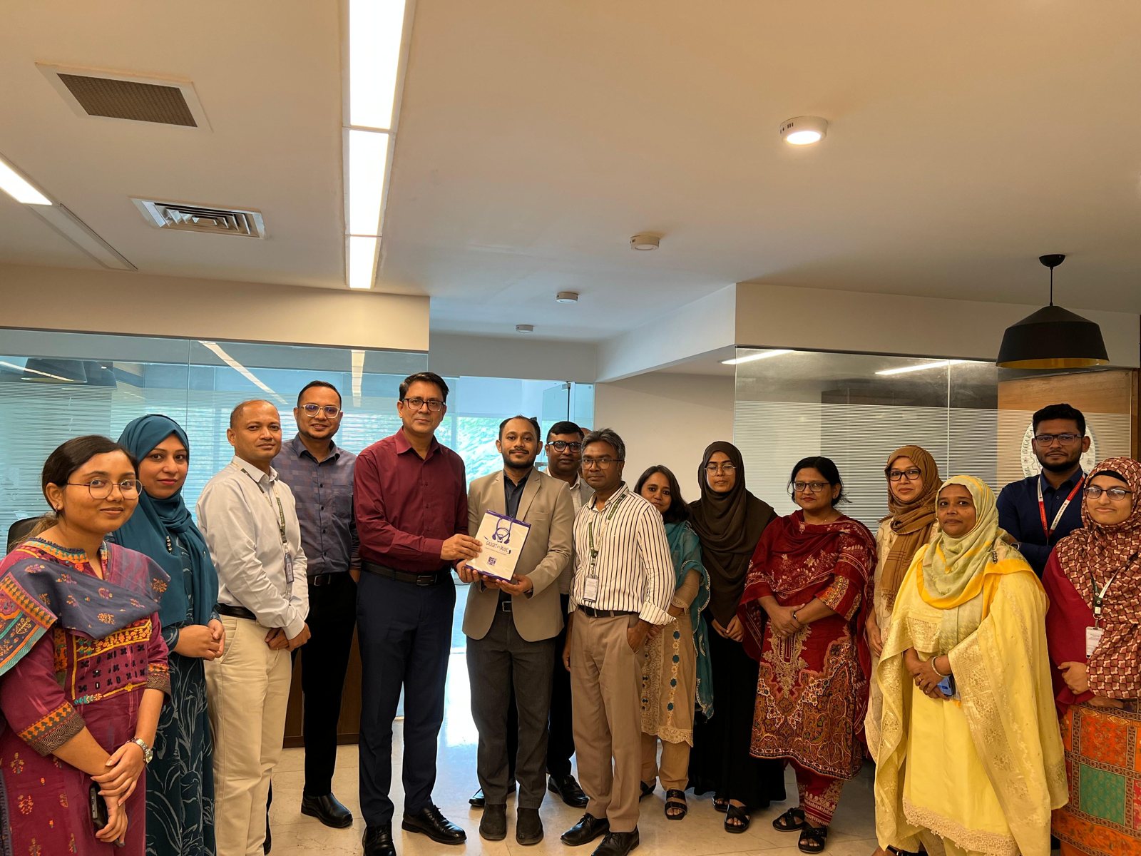 Md Jamil Hasan with colleagues celebrating together in the office